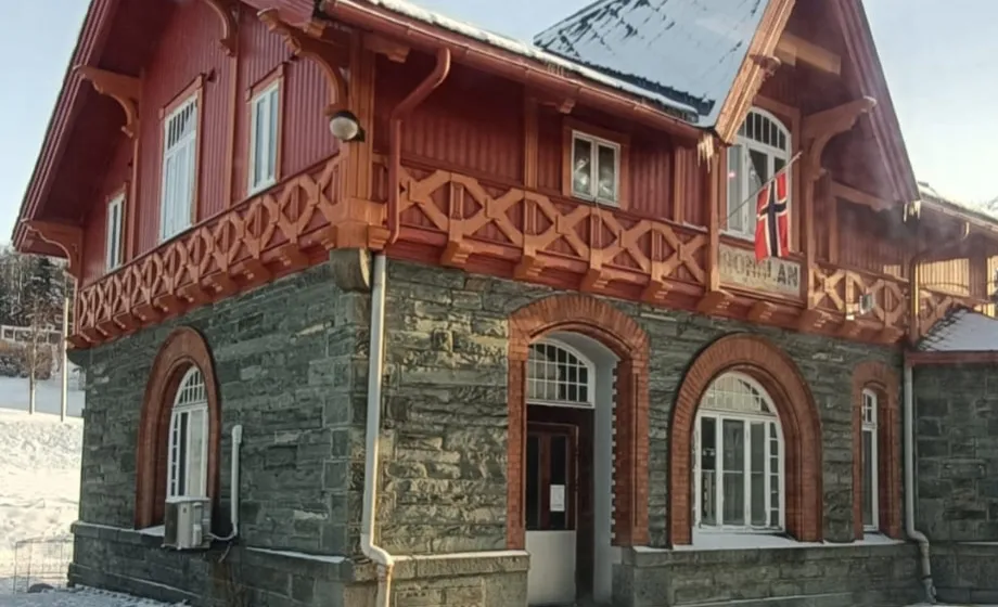 Traditionelles norwegisches Haus mit Stein und rotem Holz gebaut and verschneiter Dorfstrasse